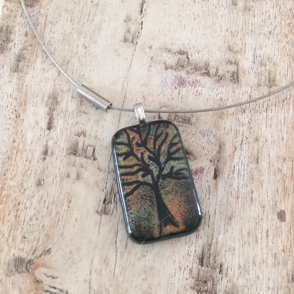 Boutique glass art tree pendant on choker wire.